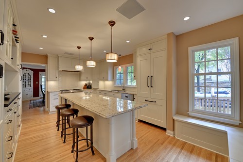 Cambria Windermere Countertop and Overhang Island Top with Off White Cabinets, Brick Pattern with Herringbone Inset Ceramic Subway Tile and Light Oak Flooring